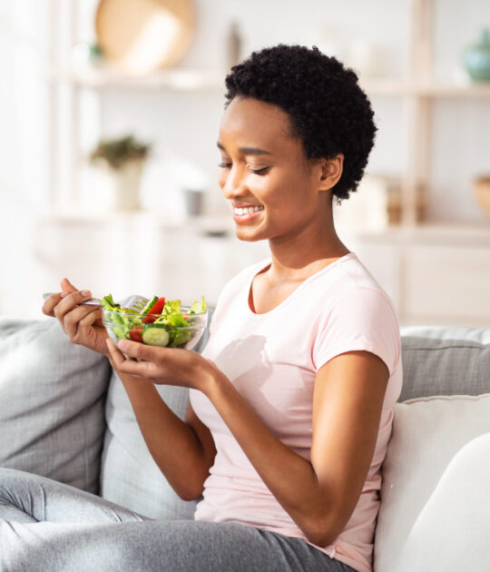 Woman eating on couch